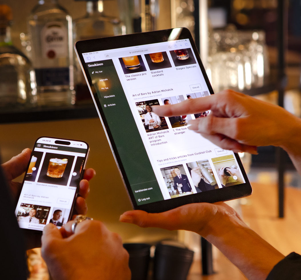 Cocktail Club Pro on a tablet and a phone behind the bar